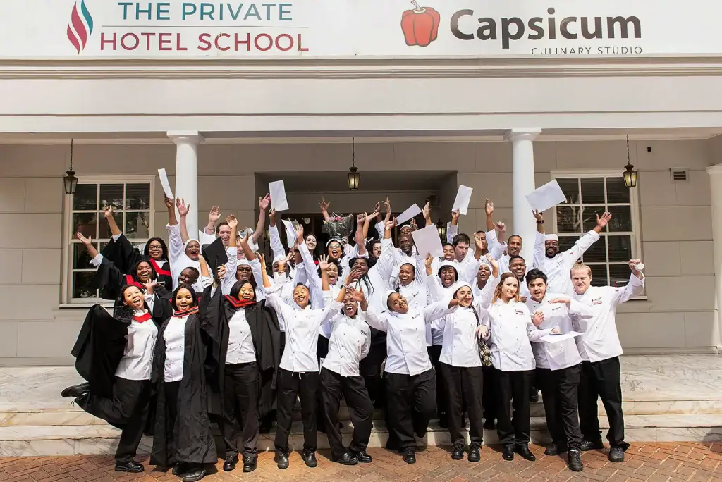 Group of culinary students celebrating graduation at Capsicum Culinary Studio – professional event and corporate photography