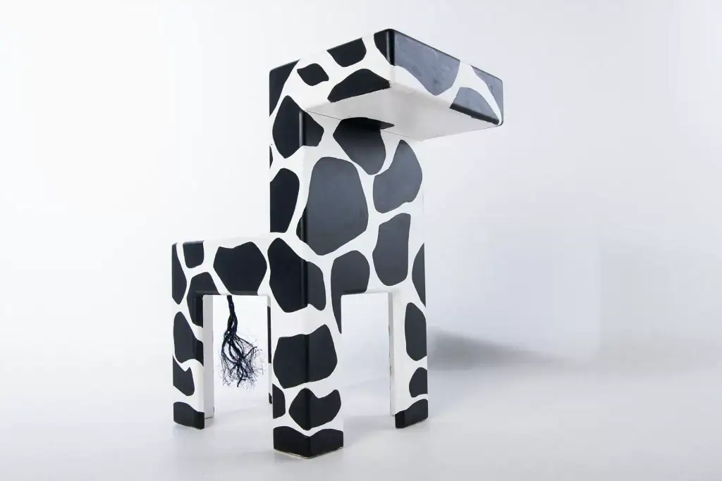 High-end studio photo of a modern black and white designer chair with giraffe pattern and tail detail, ideal for product and commercial catalogues