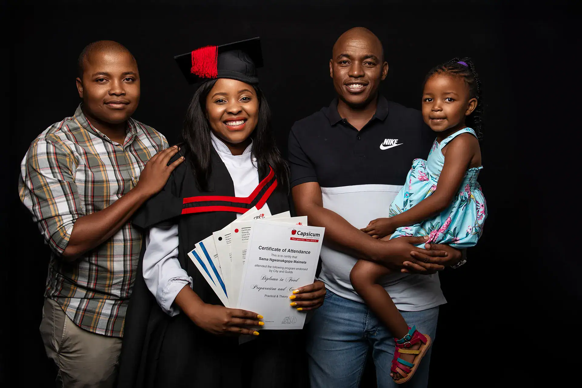 Proud Family Graduation Portrait in Johannesburg Studio Smiling graduate in academic gown holding certificates, surrounded by proud family members in a Johannesburg photography studio, capturing a milestone achievement through professional portrait photography