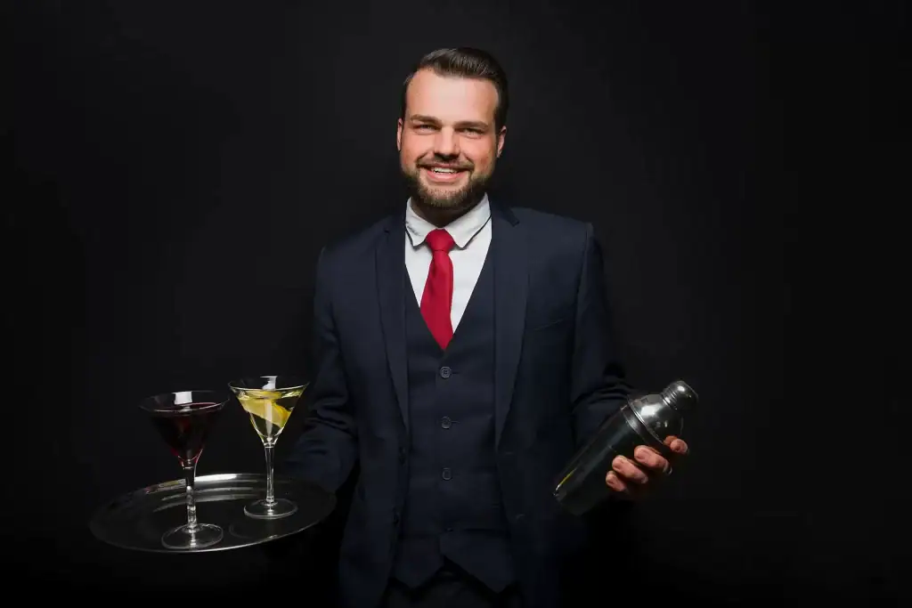 male-bartender-student-hospitality-uniform-shaker-martini-glasses.webp