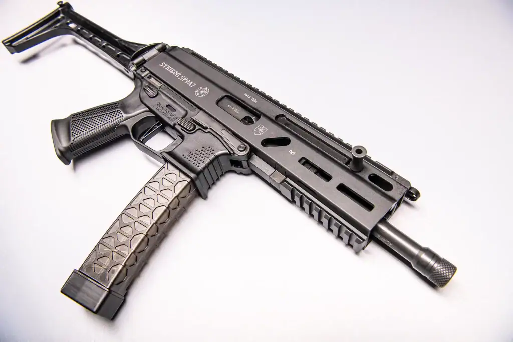 Close-up of STRIBOG SP9A3 9mm tactical sub gun featuring folding stock, M-LOK rail, and extended magazine on white background. Stock Photography