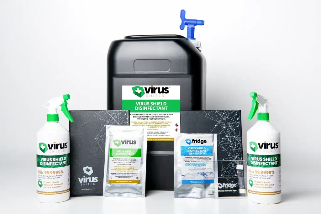 Studio image showcasing Virus Shield Disinfectant product range including sprays, sachets, jerrycan, and Fridge Shield generator for surface and air sanitation