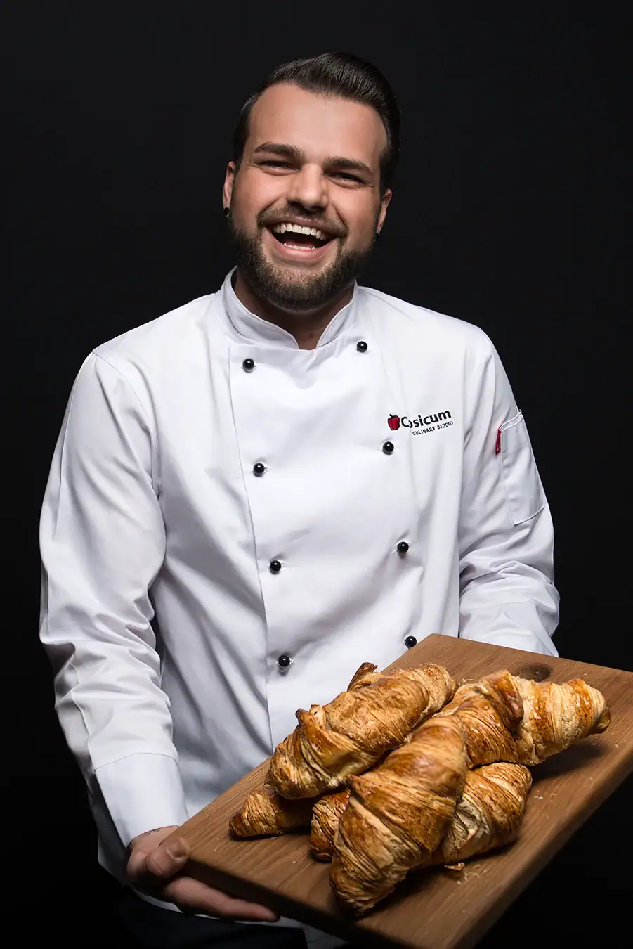Professional commercial photography of a Johannesburg chef presenting freshly baked croissants