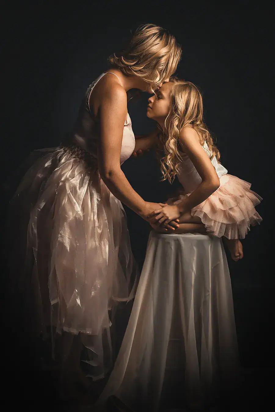 Mother kissing her daughter during a portrait photography session in Johannesburg