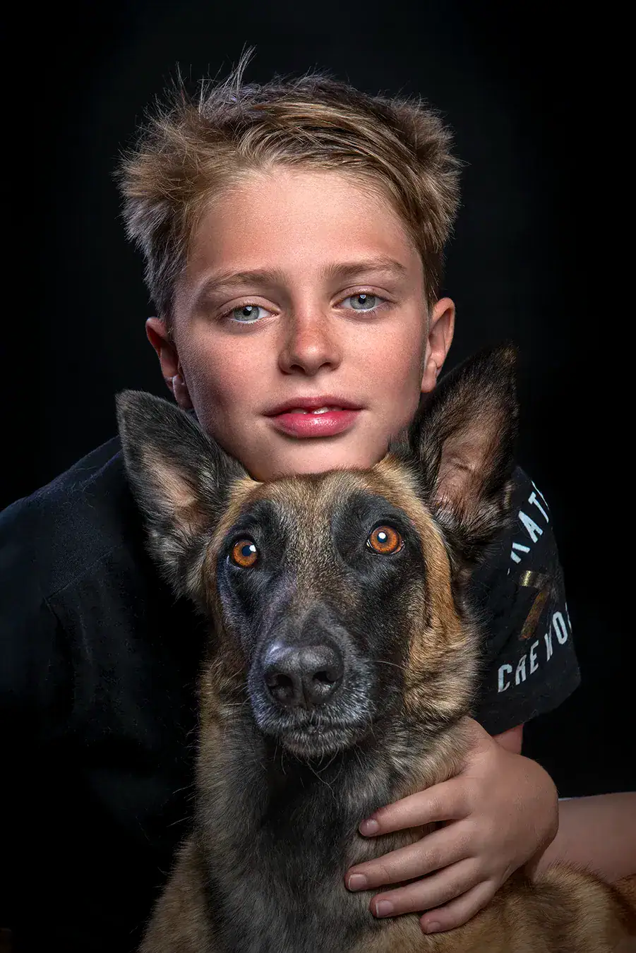 Boy with Belgian Malinois photographed in studio in Johannesburg