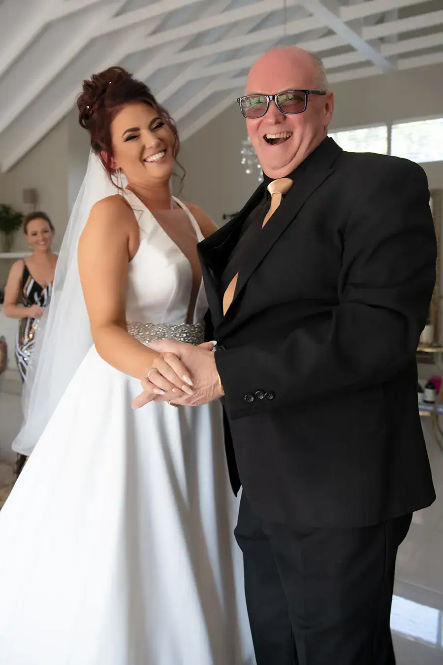 Bride laughing with her father on her wedding day