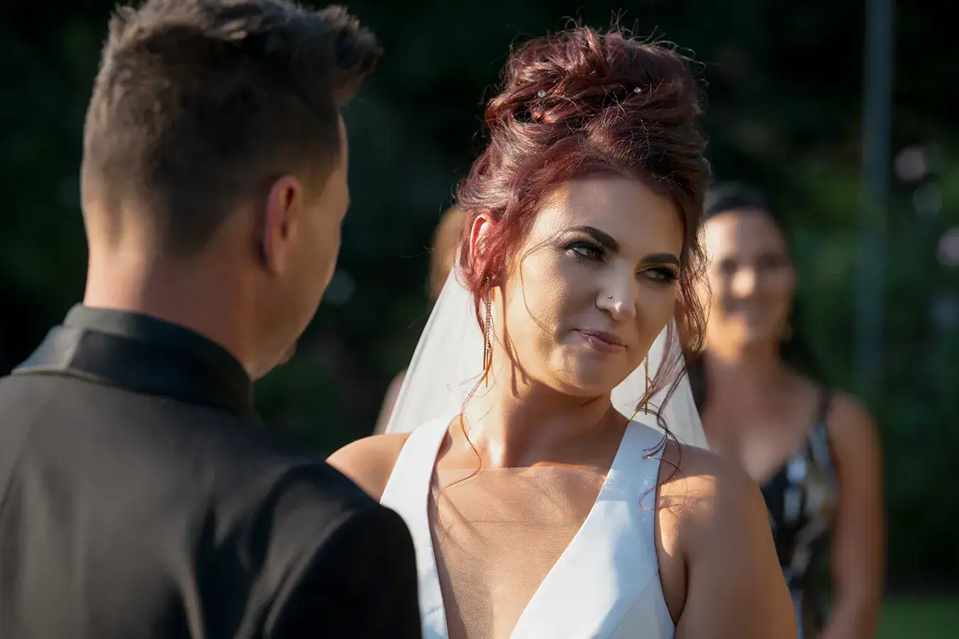 Bride looking towards the groom during their wedding ceremony